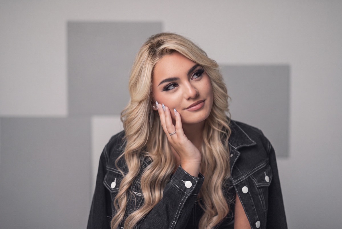 SUPPA in a black denim jacket against a grey studio wall